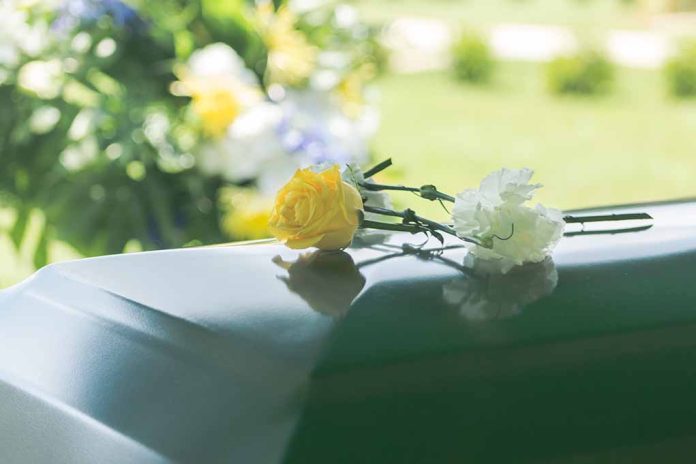A,Closeup,Of,Flowers,Atop,A,Funeral,Casket,Outdoors. Actor Dead At 49