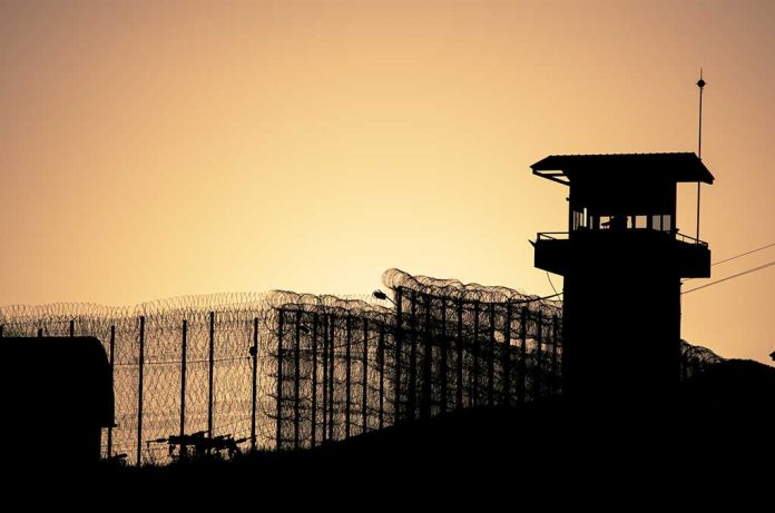 Silhouette,Of,Barbed,Wires,And,Watchtower,Of,Prison,,At,Sunset Convicted Murderer Escapes Prison, Goes On The Run