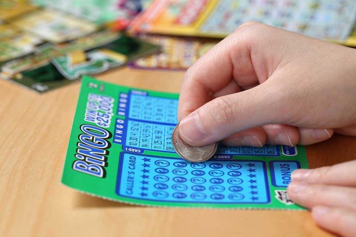 shutterstock_203186986.jpg A person scratching off a bingo lottery ticket with a coin
